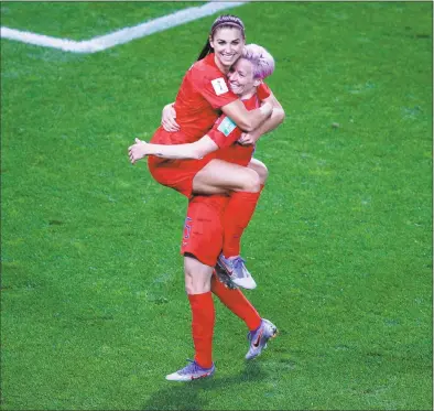  ?? Francois Mori / Associated Press ?? The United States’ Megan Rapinoe, right, congratula­tes teammate Alex Morgan after Morgan scored her fifth goal during a World Cup match against Thailand on Tuesday in Reims, France.