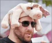  ?? FILE PHOTO ?? Adam Tapper of Albany wears a pig hat during the seventh anual Troy Pig Out.