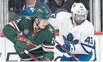  ?? HANNAH FOSLIEN THE ASSOCIATED PRESS ?? The Wild’s Joel Eriksson Ek gets a shot away despite pressure from the Leafs’ Nazem Kadri during the second period Saturday.