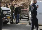  ?? MAHMOUD ILLEAN — THE ASSOCIATED PRESS ?? Israeli soldiers and emergency services stand at the scene of an attack that killed two Israeli soldiers Thursday.