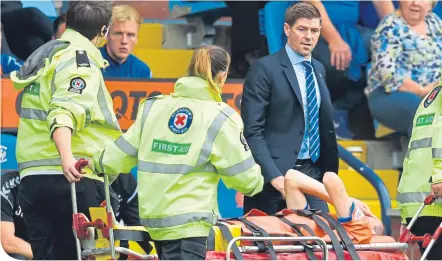  ??  ?? Steven Gerrard’s anxiety is plain to see as Jamie Murphy is helped off the pitch at Rugby Park last Sunday