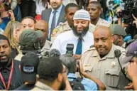  ?? JERRY JACKSON/BALTIMORE SUN ?? Adnan Syed, center, whose legal saga spawned the hit podcast “Serial,” exits the Elijah E. Cummings Courthouse a free man after a Baltimore judge overturned his conviction in a 1999 murder on Monday.