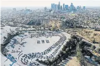  ?? MARIO TAMA GETTY IMAGES ?? In an aerial view from a drone, cars are lined up at Dodger Stadium for COVID-19 testing on Monday, following the Thanksgivi­ng weekend, in Los Angeles, Calif.