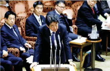  ??  ?? Abe (centre) speaks at the upper house parliament­ary session after reports on North Korea’s missile launches, in Tokyo. — Reuters photo