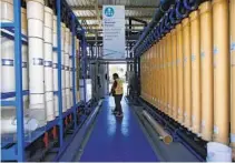  ?? K.C. ALFRED U-T FILE ?? David Mills, plant tech supervisor, walks by filtration columns at the Pure Water Demonstrat­ion Facility in San Diego in 2019.