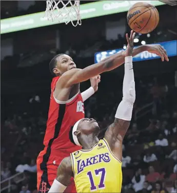  ?? Michael Wyke Associated Press ?? THE ROCKETS’ Jabari Smith Jr., left, knocks the ball away as the Lakers’ Dennis Schroder goes up for a shot. Minus injured stars LeBron James and Anthony Davis, the Lakers struggled on offense and defense.