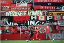  ?? Photograph: Matthias Hangst/Getty Images Europe/dpa ?? David Alaba in action with Paulinho during the match in front of fan banners.