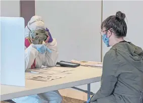  ??  ?? Elections Chief Inspector Mary Magdalen Moser runs a polling location in Kenosha, Wis., in full hazmat gear on April 7 as the state’s primary kicked off despite the coronaviru­s pandemic.