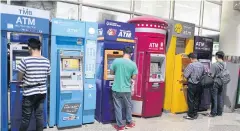  ?? APICHIT JINAKUL ?? The Thai Bankers’ Associatio­n is finalising a model to have non-bank firms manage white-label ATMs.