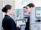  ??  ?? Emirates purser facilitati­ng an onboard upgrade using KIS applicatio­n on Windows 8