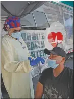  ?? (AP/Elise Amendola) ?? Nurse Tanya Markos administer­s a coronaviru­s test on patient Juan Ozoria at a mobile covid-19 testing unit Thursday in Lawrence, Mass.