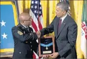  ??  ?? NEW YORK National Guard Sgt. Maj. Louis Wilson accepts the honor on behalf of Pvt. Henry Johnson.