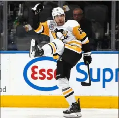  ?? Bruce Bennett/Getty Images ?? The Penguins’ Jason Zucker scores his 300th NHL point at 1:08 of the second period Friday against the Toronto Maple Leafs at the Scotiabank Arena in Toronto.