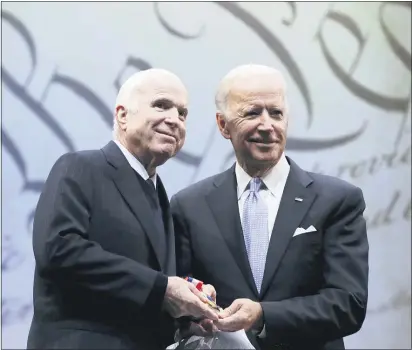  ?? MATT ROURKE — AP ?? In this Oct. 16, 2017, file photo Sen. John McCain, R-Ariz., receives the Liberty Medal from Chair of the National Constituti­on Center’s Board of Trustees, former Vice President Joe Biden, in Philadelph­ia. Cindy McCain is going to bat for Biden, including lending her voice to a video aired during the Democratic National Convention and focused on Biden’s close friendship with her late husband, Sen. John McCain.