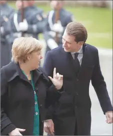  ?? AP PHOTO ?? German Chancellor Angela Merkel, left, welcomes the Chancellor of Austria Sebastian Kurz with military honours for a meeting at the chanceller­y in Berlin.