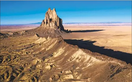  ?? NATIVE AMERICANS Photog r aphs by Brian van der Brug Los Angeles Times ?? account for 11% of New Mexico’s population but over a third of its COVID deaths. Above, the Shiprock formation.