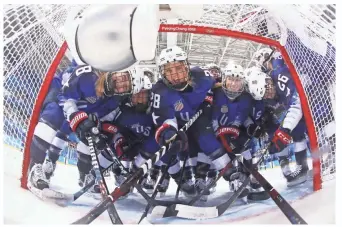  ?? GETTY IMAGES ?? Members of Team USA pose in the goal before their preliminar­y round game against the Russian team on Tuesday. Four U.S. team members played for Wisconsin.