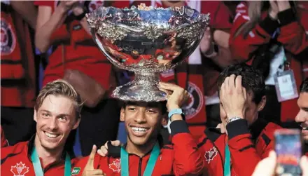  ?? — reuters ?? On top of the world: Canada’s Felix auger-aliassime celebrates with the davis Cup after the final against australia.