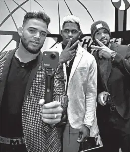  ??  ?? White Sox players Yoan Moncada, Luis Robert, and Jose Abreu have some fun on opening day of SoxFest at McCormick Place West in Chicago on Friday.