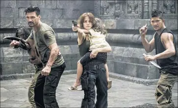  ?? Vertical Entertainm­ent ?? FRANK GRILLO, left, Bojana Novakovic and Iko Uwais are ready to fight in “Beyond the Skyline.”