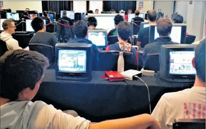  ??  ?? Some gamers took a step back into the past to play on old television­s which were dusted off for the event.