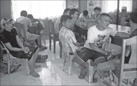  ??  ?? Fugitives from the North Cotabato Provincial Jail in Kidapawan City wait in a village hall after they were recaptured in Kabacan town yesterday. AFP