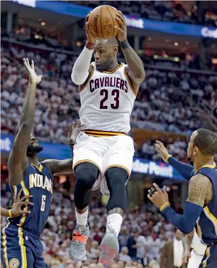  ?? AP ?? Cleveland Cavaliers’ LeBron James catches a pass against Indiana Pacers’ Lance Stephenson (left) and Monta Ellis (right) during Game 2 of the first round NBA playoff series. —