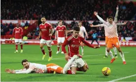  ?? Photograph: Molly Darlington/Reuters ?? Blackpool players want a foul given for Neco Williams’ challenge on James Husband.