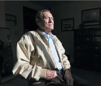  ?? PHOTOS BY NATHAN HOWARD — THE ASSOCIATED PRESS ?? Pearl Harbor survivor and World War II Navy veteran David Russell, 101, poses for a photo at his home on Nov. 22 in Albany, Ore.