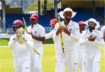  ??  ?? Shane Dowrich (left), Shannon Gabriel, Roston Chase and Devendra Bishoo (right) of West Indies celebrate winning on day 5 of the 1st Test between West Indies and Sri Lanka at Queen’s Park Oval, Port of Spain, Trinidad. — AFP photo