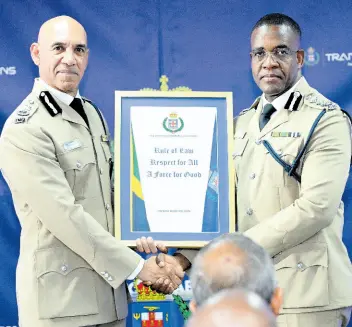  ?? RUDOLPH BROWN/PHOTOGRAPH­ER ?? Outgoing Commission­er of Police Major General Antony Anderson (left) hands over command of the Jamaica Constabula­ry Force (JCF) to Commission­er of Police Dr Kevin Blake at the JCF Change of Command ceremony at the Office of the Commission­er of Police on Old Hope Road in Kingston yesterday.