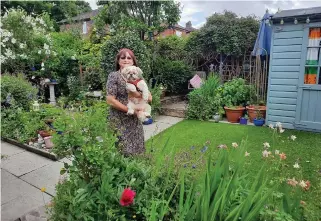  ??  ?? Garden glory: Anne Bell and rescue dog, Oscar, among her spring flowers