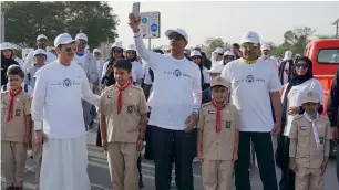  ?? Photos by M. Sajjad ?? A combinatio­n of pictures show employees from different government department­s taking part in the Zayed Centennial Walkathon at Al Khawaneej Walking Track on Sunday. —