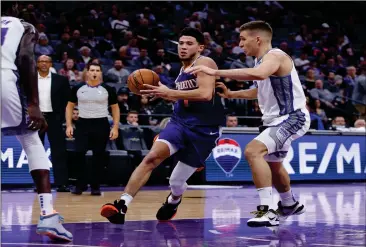  ?? ASSOCIATED PRESS ?? PHOENIX SUNS GUARD DEVIN BOOKER (left) drives to the basket against Sacramento Kings guard Bogdan Bogdanovic during the second half of a preason game in Sacramento, Calif., last Thursday.