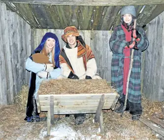  ?? SPECIAL TO THE EXAMINER ?? Mary and her husband Joseph with a little help from a shepherd boy (Kate Oliver, Josiah and Gideon Latone) introduced baby Jesus to passing travellers during the Norwood Pentecosta­l Churchís annual Journey to Bethlehem, a live interactiv­e retelling of...