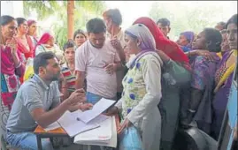  ?? NITIN KANOTRA/HT ?? Villagers waiting for their turn at a relief camp in Nowshera on Monday.