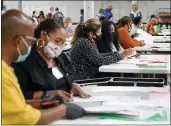  ?? NICOLE CRAINE — THE NEW YORK TIMES ?? Workers recount election ballots by hand in Gwinnett County, Georgia, on Nov. 13. Prosecutor­s in Georgia appear increasing­ly likely to open a criminal investigat­ion of President Donald Trump over his attempts to overturn the results of the state’s 2020electi­on.