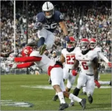  ?? CHRIS KNIGHT — THE ASSOCIATED PRESS ?? Penn State’s Saquon Barkley (26) hurdles Rutgers’ Kiy Hester (2) during the second half of a game in State College Saturday.