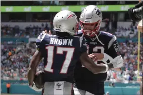  ?? THE ASSOCIATED PRESS ?? In this Sept. 15, 2019, file photo, then-New England Patriots quarterbac­k Tom Brady (12) and wide receiver Antonio Brown (17) celebrate after Brown scored a touchdown during the first half at an NFL football game against the Miami Dolphins, in Miami Gardens, Fla. Antonio Brown practices with the Tampa Bay Buccaneers for the first time, Wednesday, Nov. 4, 2020, and is eager to take advantage of his latest opportunit­y to continue his NFL career.