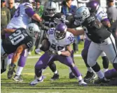  ?? John Cordes / Associated Press ?? Vikings’ Adrian Peterson (28) tries to avoid being tackled by the Raiders.