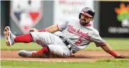  ?? DAVID JABLONSKI / STAFF ?? The Nationals’ Adam Eaton slides into third base against the Reds on Opening Day in 2018. Eaton, who played three seasons at Miami, has retired.