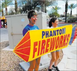  ?? K.M. Cannon ?? Las Vegas Review-journal @Kmcannonph­oto Next Generation Albion Soccer Club mom Paula Price-foschetti and daughter Savannah Foschetti, 13, draw customers to their fireworks booth Thursday.