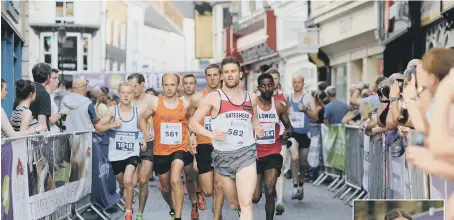  ??  ?? Runners race through the streets of Durham last night