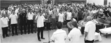  ??  ?? Councillor Aries Leong Chin Lim (at the microphone) leads RC members in making the pledge to serve well, witnessed by Dr Sim (centre – front row facing the audience), Yii (right) and deputy mayor Julaihi Mohomad (left).