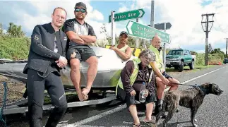  ?? PHOTO: DOMINICO ZAPATA/FAIRFAX NZ ?? Dwayne Mcguire, John Puutu, Kipa Fowell, Roy Rogers and Jason Hubbard used a jetboat to rescue people, and the dog pictured, from floodwater­s in Edgecumbe.