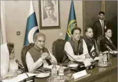  ?? AP ?? Pakistan’s Prime Minister Imran Khan (centre) attends a briefing at the foreign ministry in Islamabad, August 24