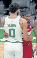  ?? ELISE AMENDOLA / AP ?? Celtics star Jayson Tatum hugs Wizards star Bradley Beal on Friday. With Tatum testing positive for the coronaviru­s, the league is looking to avoid on court interactio­n before and after games to prevent spread.