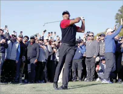  ?? ?? The Associated Press
Tiger Woods hits his approach shot off the fairway on the first hole during the final round of the Genesis Invitation­al golf tournament at Riviera Country Club in the Pacific Palisades area of Los Angeles.