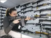  ?? ELAINE THOMPSON — ASSOCIATED PRESS ?? A gun-shop owner tests a Ruger AR-15semi-automatic rifle, the same model used in the Texas church shooting.