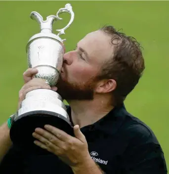  ?? (Photo by Matt Dunham, AP) ?? Shane Lowry holds and kisses the claret jug after winning the British Open Sunday.